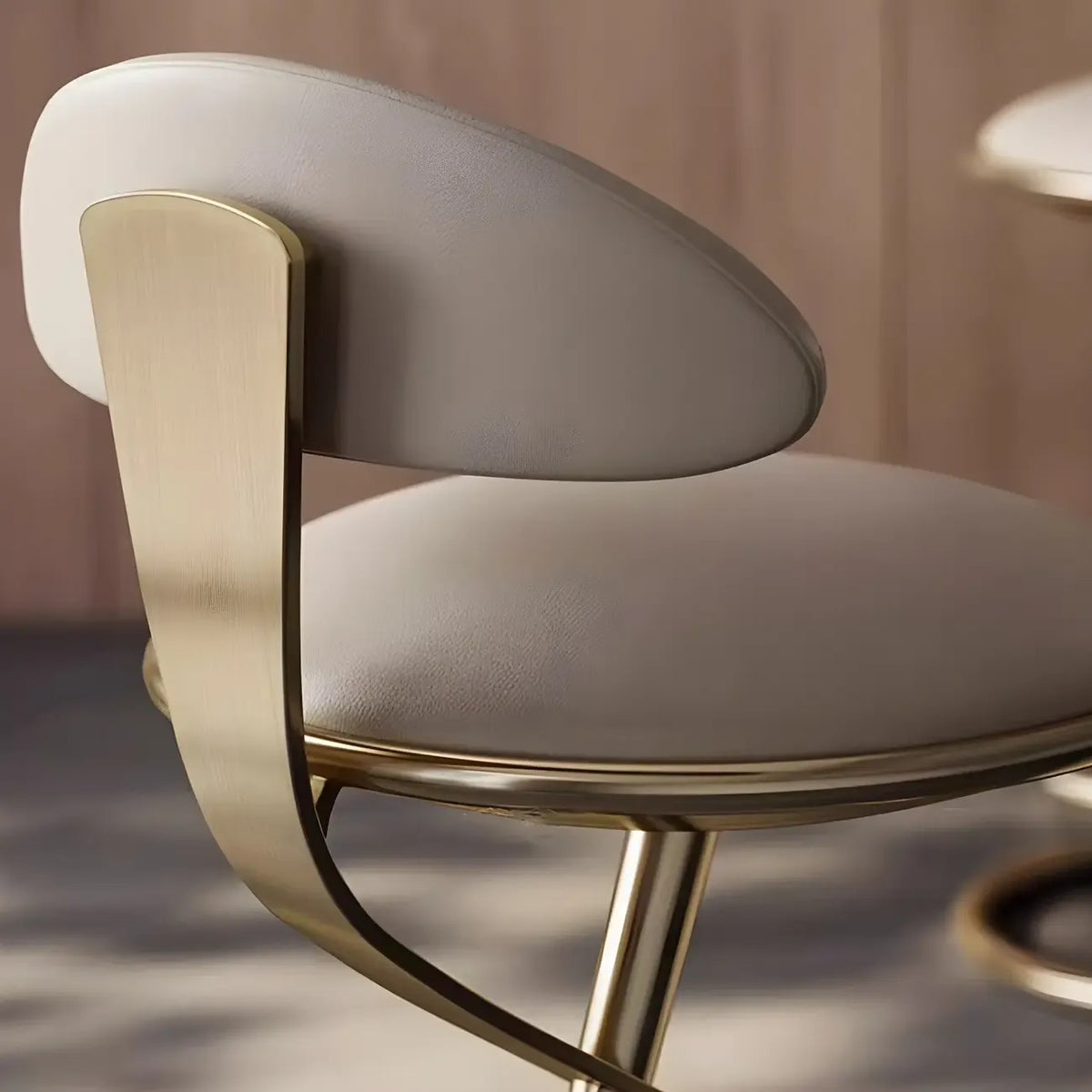 Luxe barkruk met strak beige leer en een goudkleurig metalen frame
